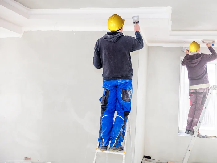 Construction workers fill the ceiling