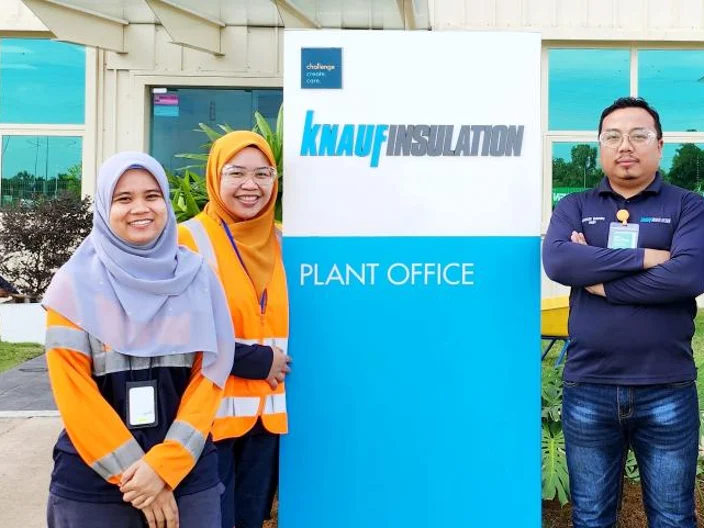 Malaysian workers stand outside Knauf Plant Office
