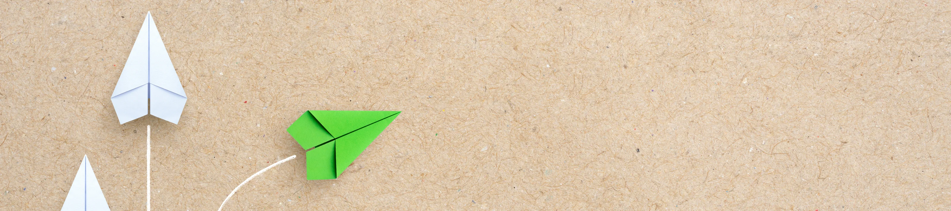 Group of white paper plane in one direction and one green paper 