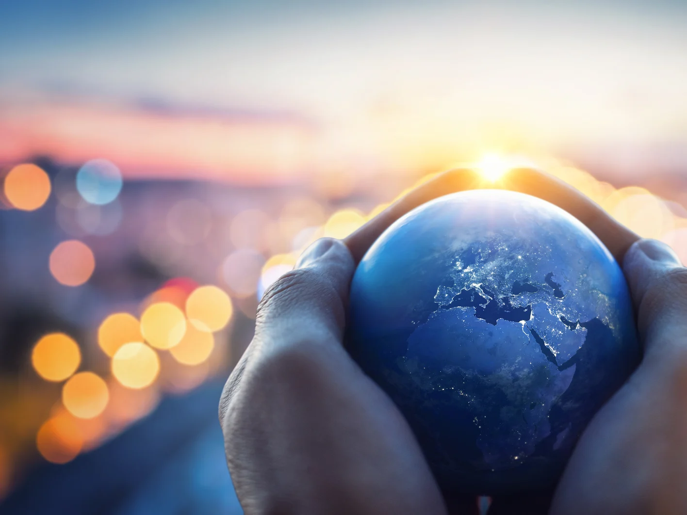 The globe Earth in the hands of man against the night city. Concept on business, politics, ecology and media. Earth day abstract background. Elements of this image furnished by NASA
