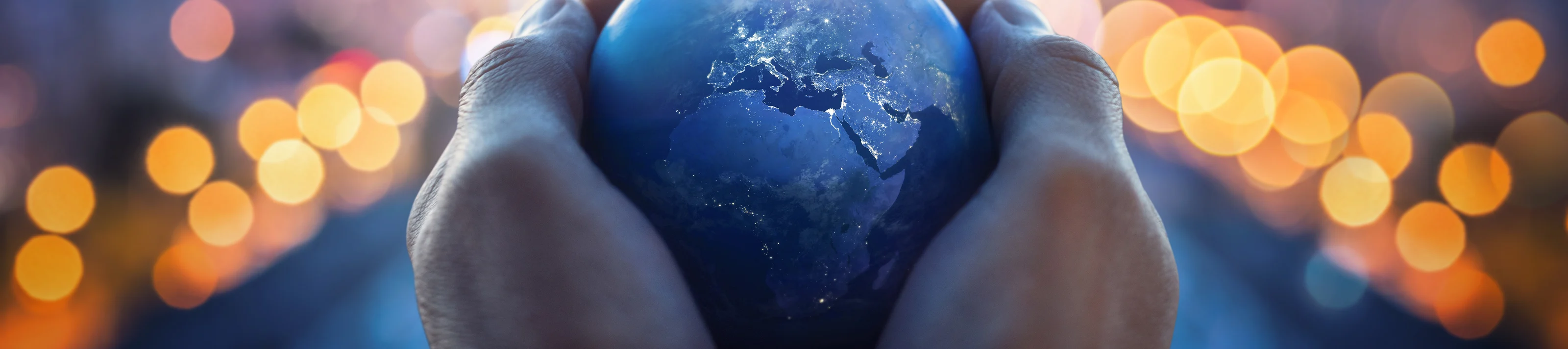 The globe Earth in the hands of man against the night city. Concept on business, politics, ecology and media. Earth day abstract background. Elements of this image furnished by NASA