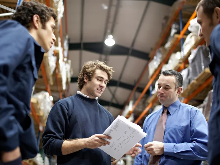Manager and workers in warehouse