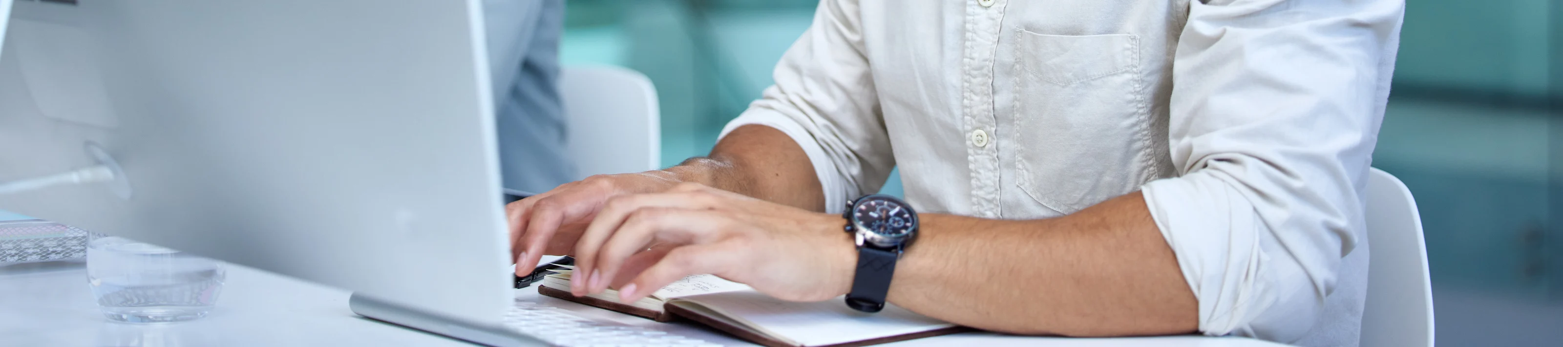 Business man, call center and web support communication at a computer in a office. Phone conversation, smile and male worker with contact us, crm and customer service job in a consulting agency