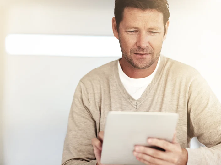 Man Looking At Tablet