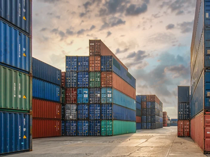 perspective view of containers at containers yard with forklift and truck
