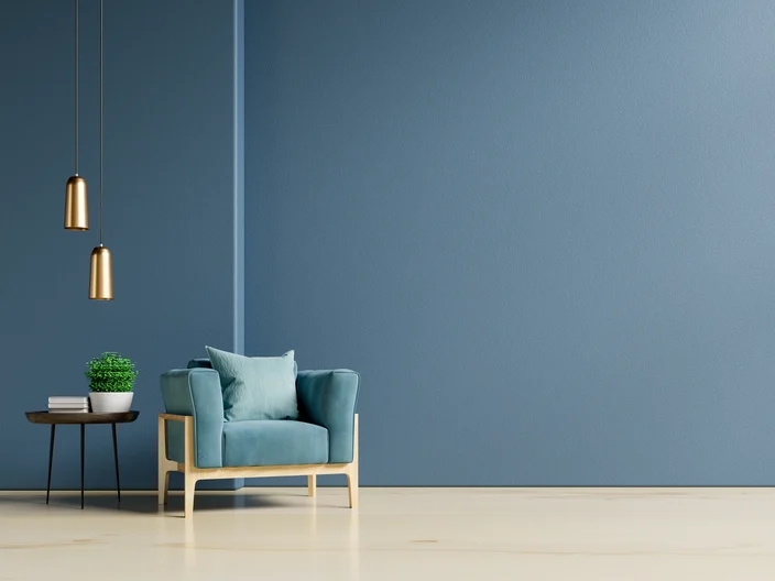 The interior has a armchair on empty dark blue wall background.