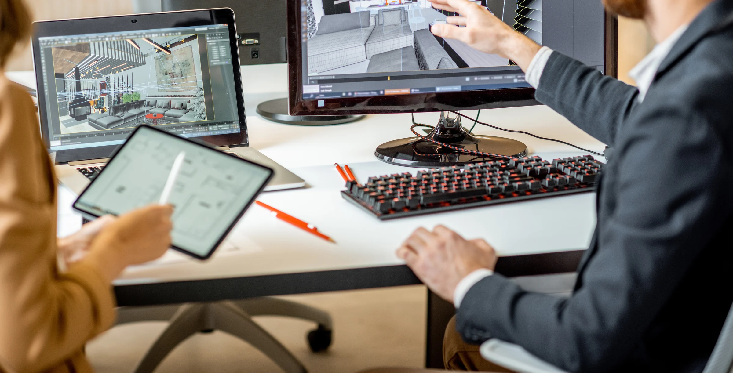 Two creative office employees making interior design on the computer and digital tablet at