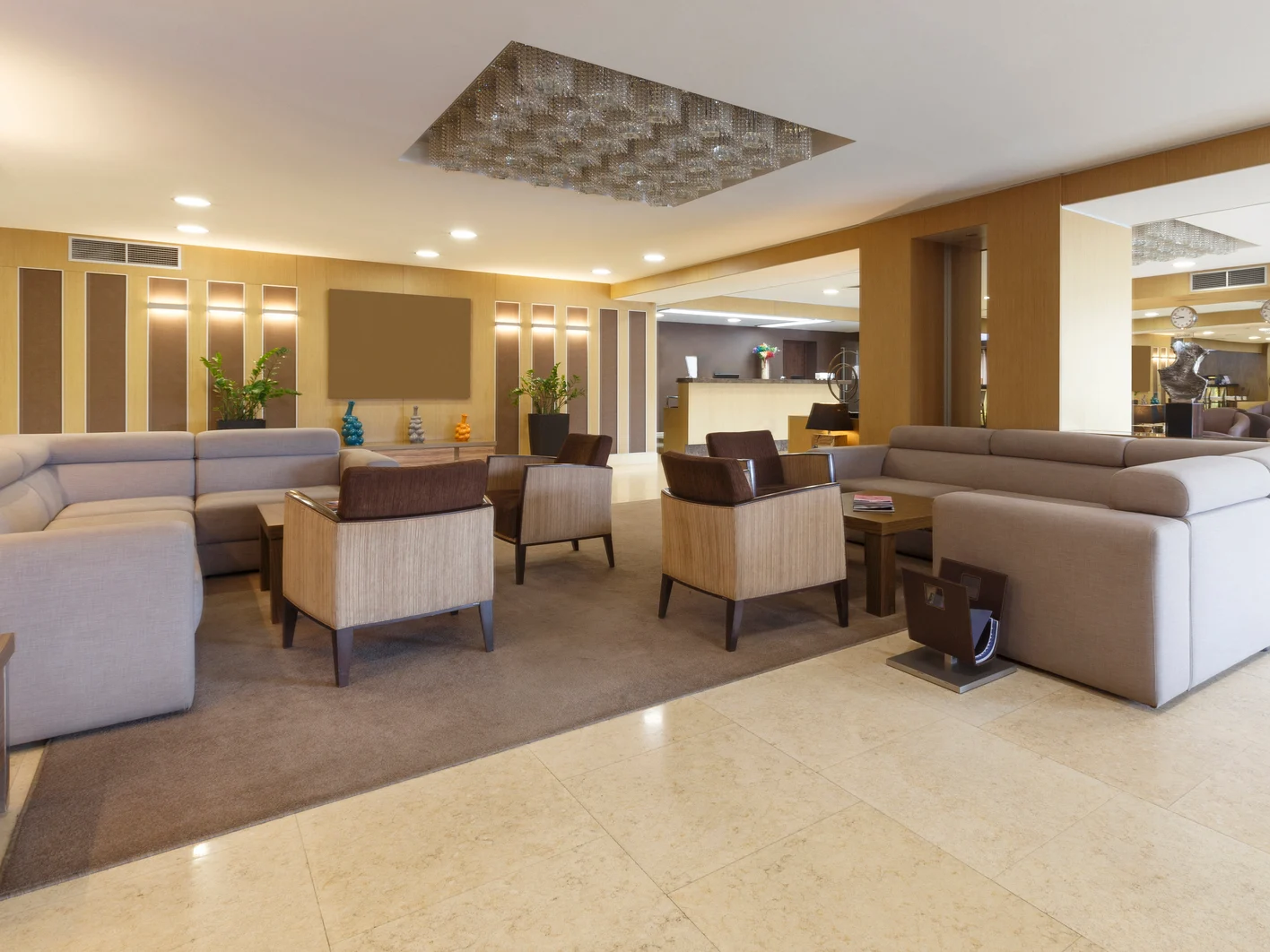 Gray sofas and armchairs in hotel lounge room
